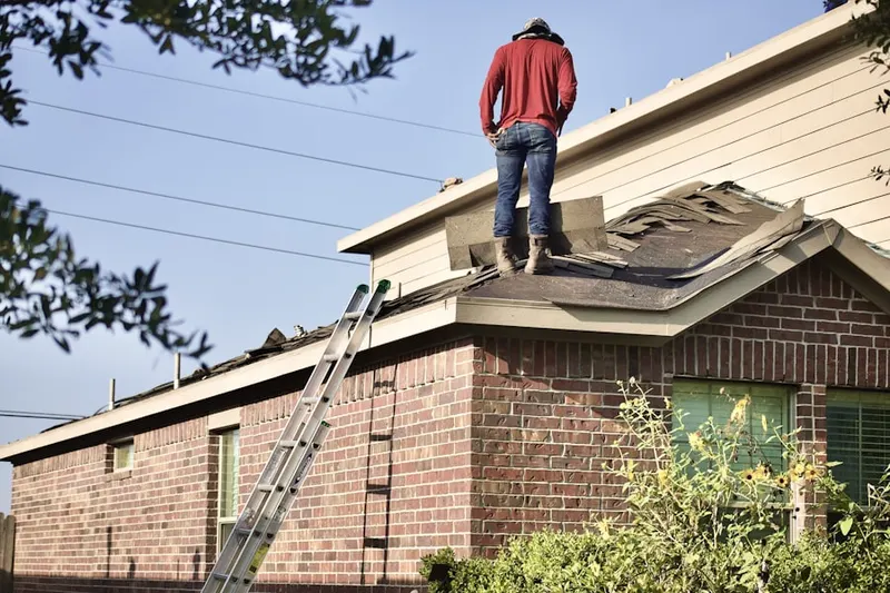 Professional roofer working on a residential roof in Crestwood Village